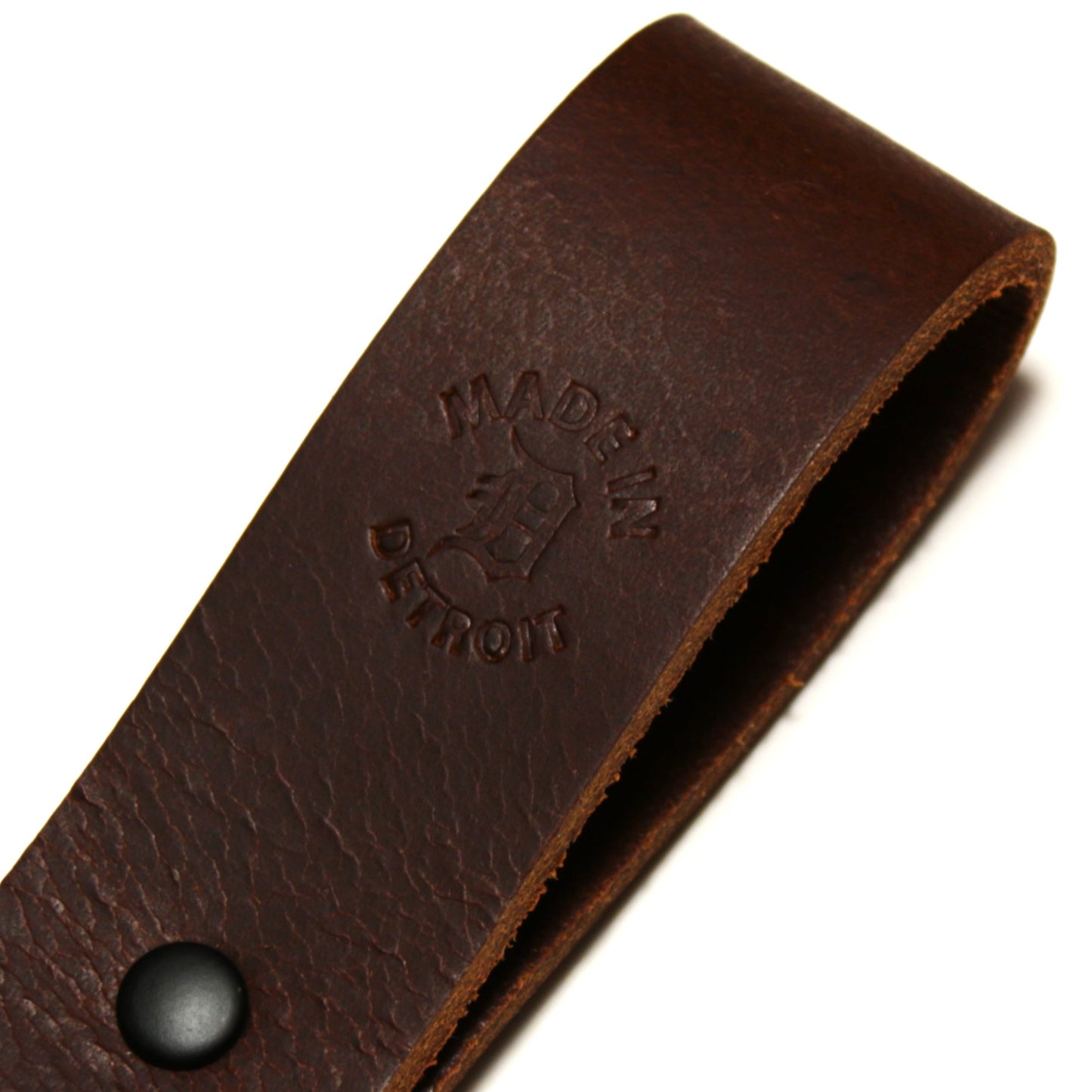 Brown leather strap with 'Made in Detroit' makers mark on a white background
